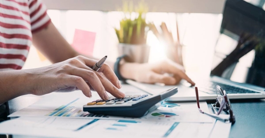 Woman calculating or checking balance