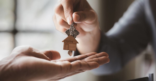 Agent handing the house keys to a new owner